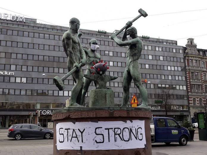 estátua coronavírus Helsinque emprego países nórdicos